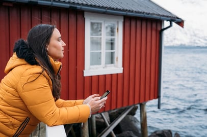 tourist-holding-smartphone-enjoying-view-of-lofote-2024-12-31-16-20-58-utc